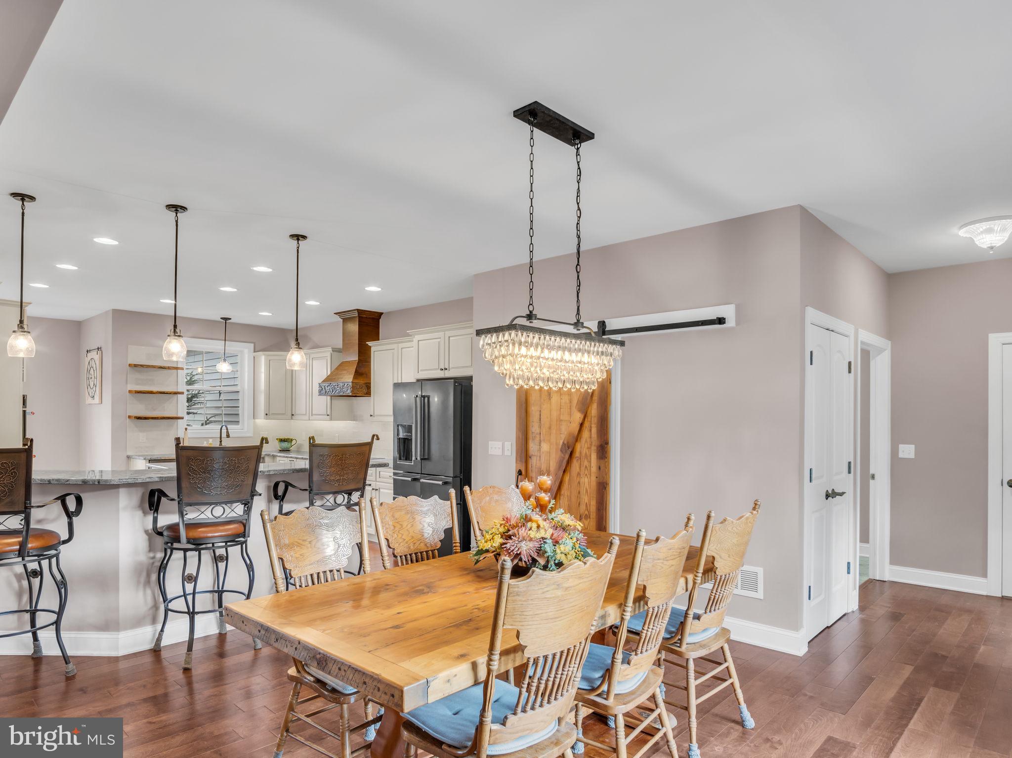 984 Pine Road Carlisle, PA 17015 - Photo 14 of 70 a view of a dining room and livingroom with furniture wooden floor a chandelier