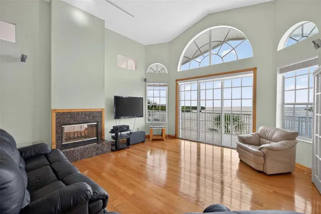 a view of a roof deck with couches and wooden floor
