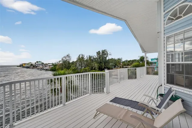 a view of a house with a large window and wooden floor