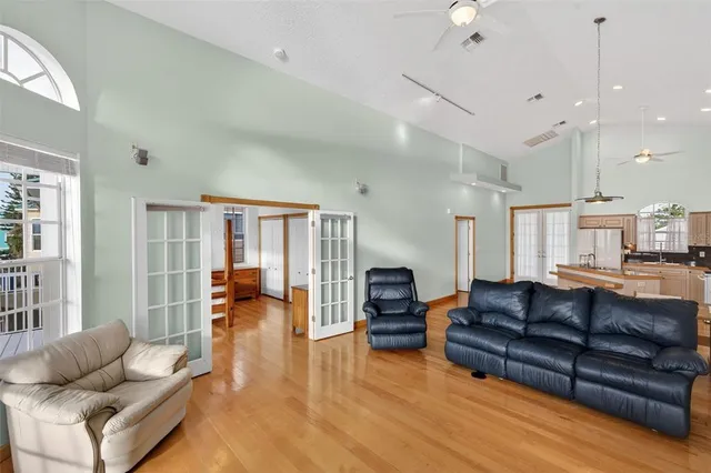 a spacious en suite bathroom with a double vanity sink a large mirror and a bathtub