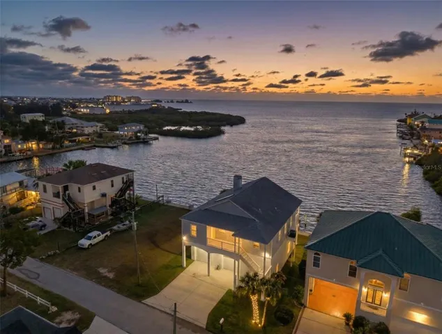 an aerial view of a house with a lake view