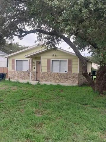 a front view of house with yard and green space