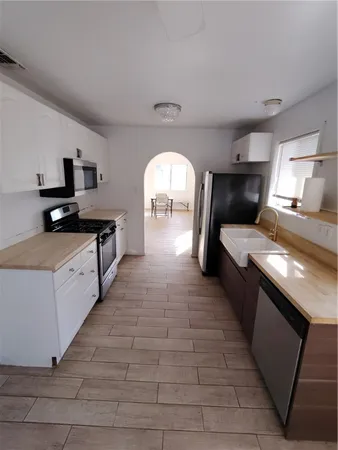 a kitchen with a sink and a stove top oven