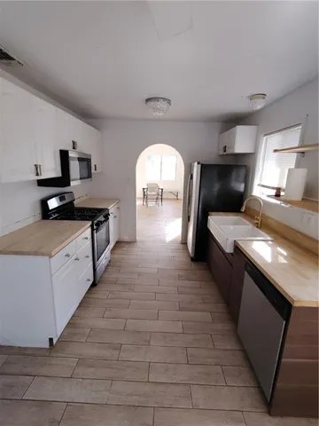 a kitchen with a sink and a stove top oven