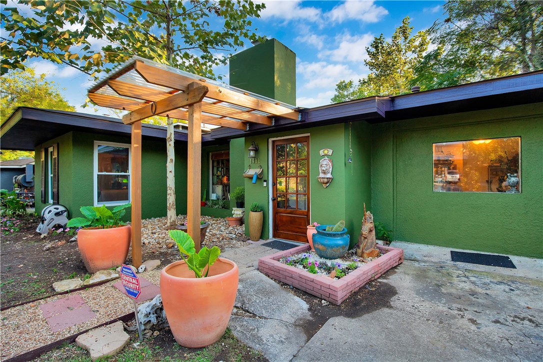 1411 Bentwood Road Austin, TX 78722 - Photo 1 of 1 a view of a patio with couches table and chairs and potted plants
