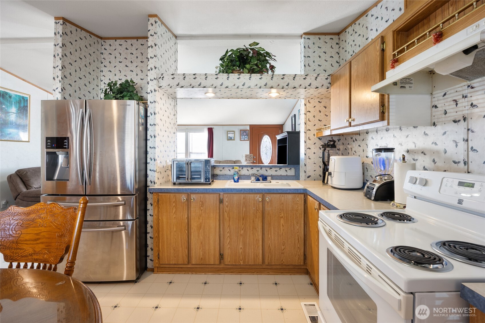 643 Kristina Road Othello, WA 99344 - Photo 11 of 33 a kitchen with stainless steel appliances a stove a sink and a refrigerator
