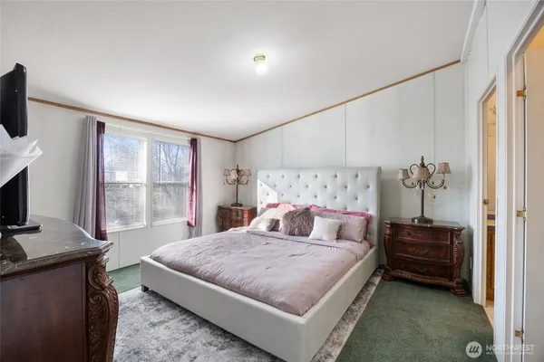 a bedroom with a bed and a television