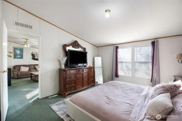 a bedroom with a bed and window