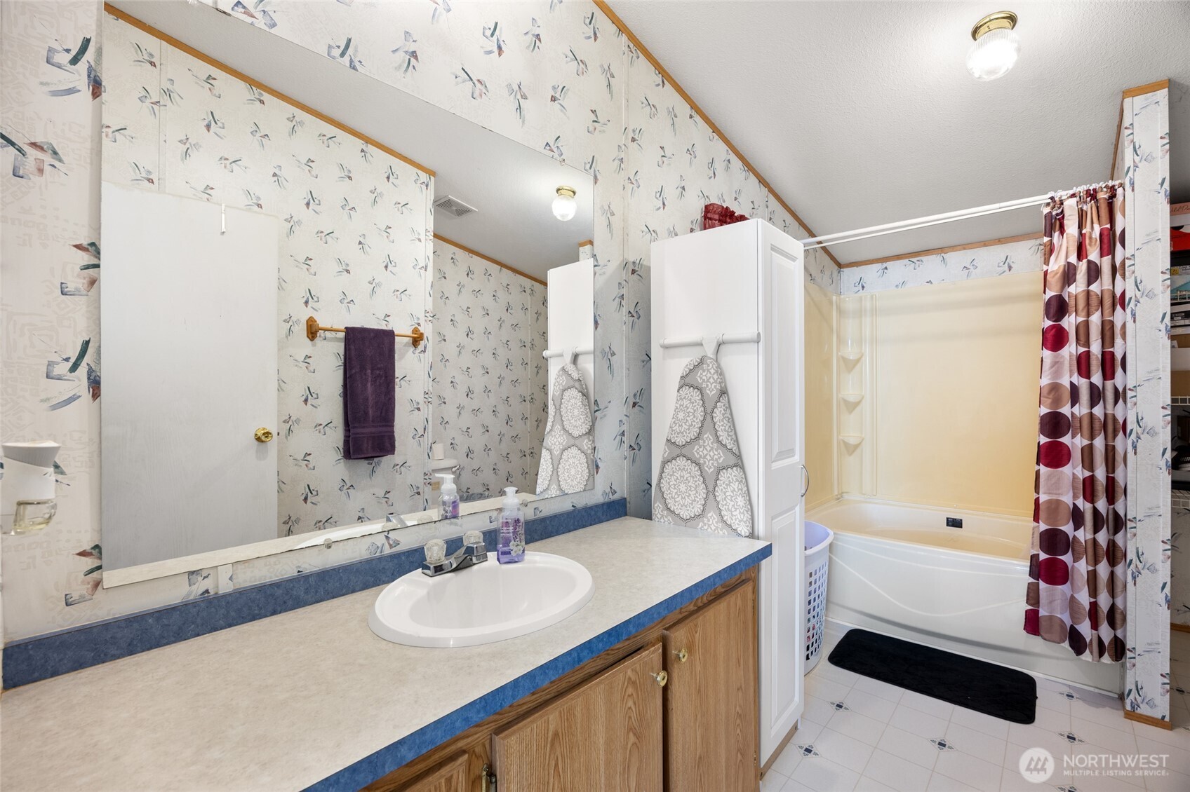 643 Kristina Road Othello, WA 99344 - Photo 15 of 33 a bathroom with a granite countertop sink a mirror a shower and a bathtub