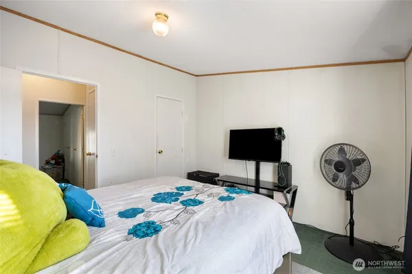 a bedroom with a bed and a table in it