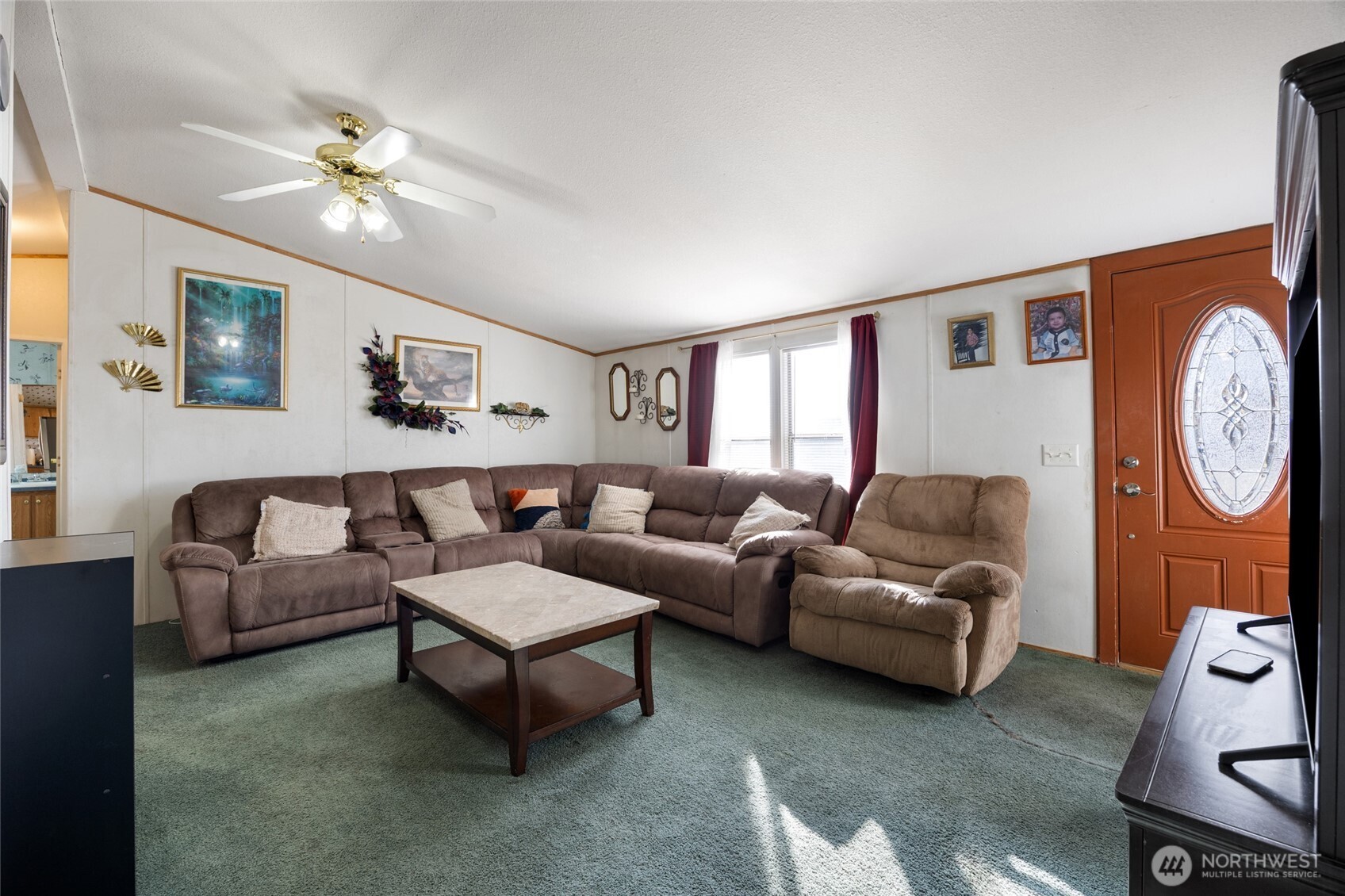 643 Kristina Road Othello, WA 99344 - Photo 6 of 33 a living room with furniture a clock on the wall and a window