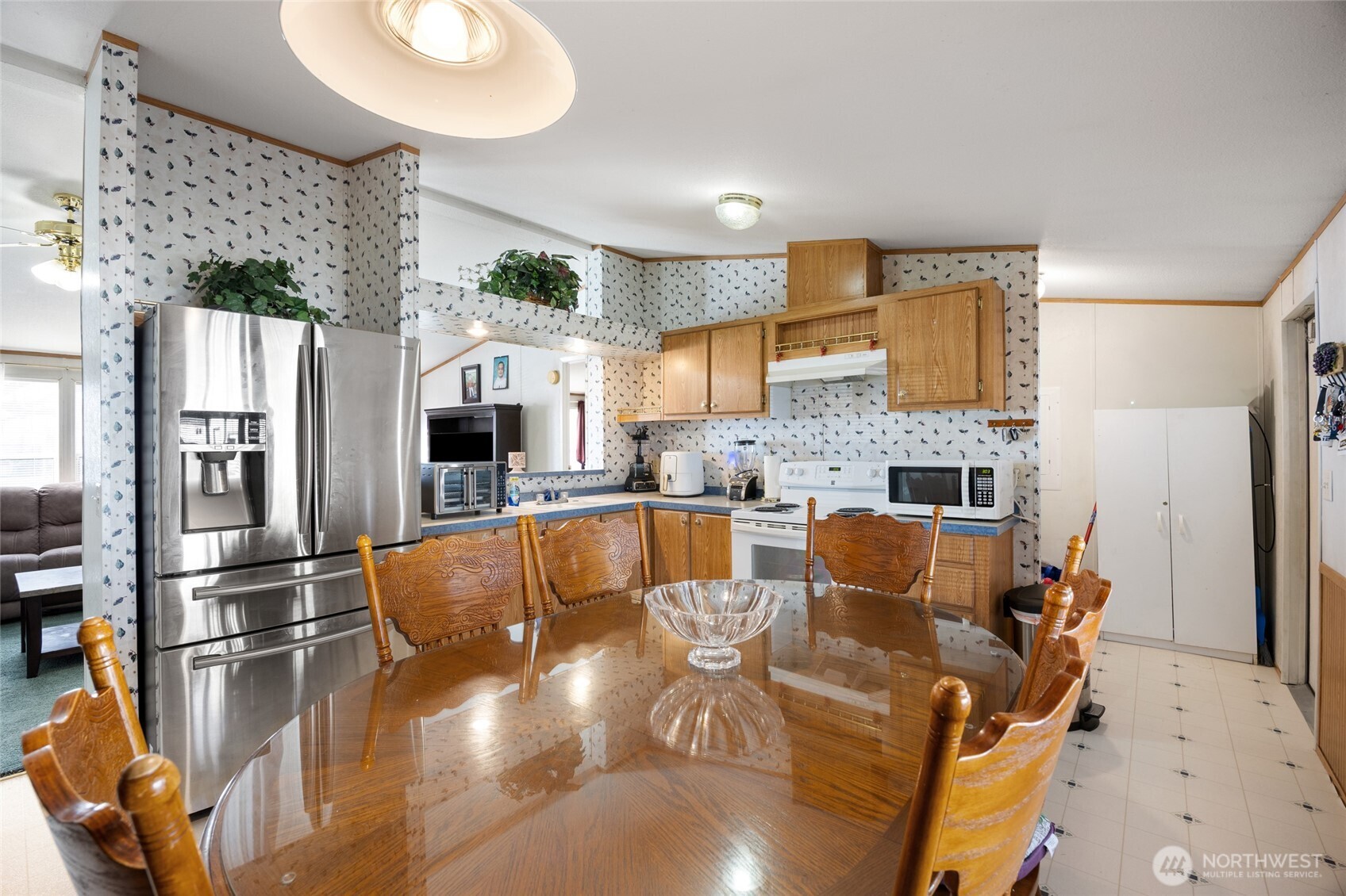 643 Kristina Road Othello, WA 99344 - Photo 10 of 33 a large kitchen with stainless steel appliances granite countertop a refrigerator a oven a sink dishwasher and white cabinets with wooden floor