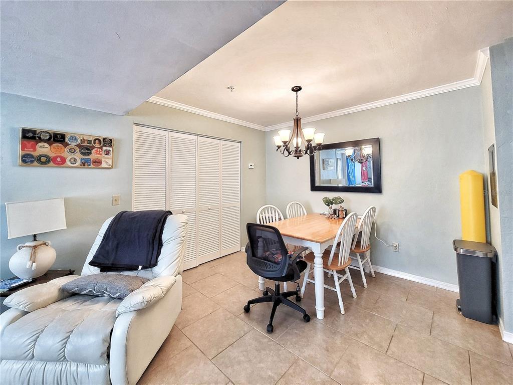 2360 Southwest Archer Road, Unit 801 Gainesville, FL 32608 - Photo 11 of 27 a living room with furniture a dining table and a chandelier