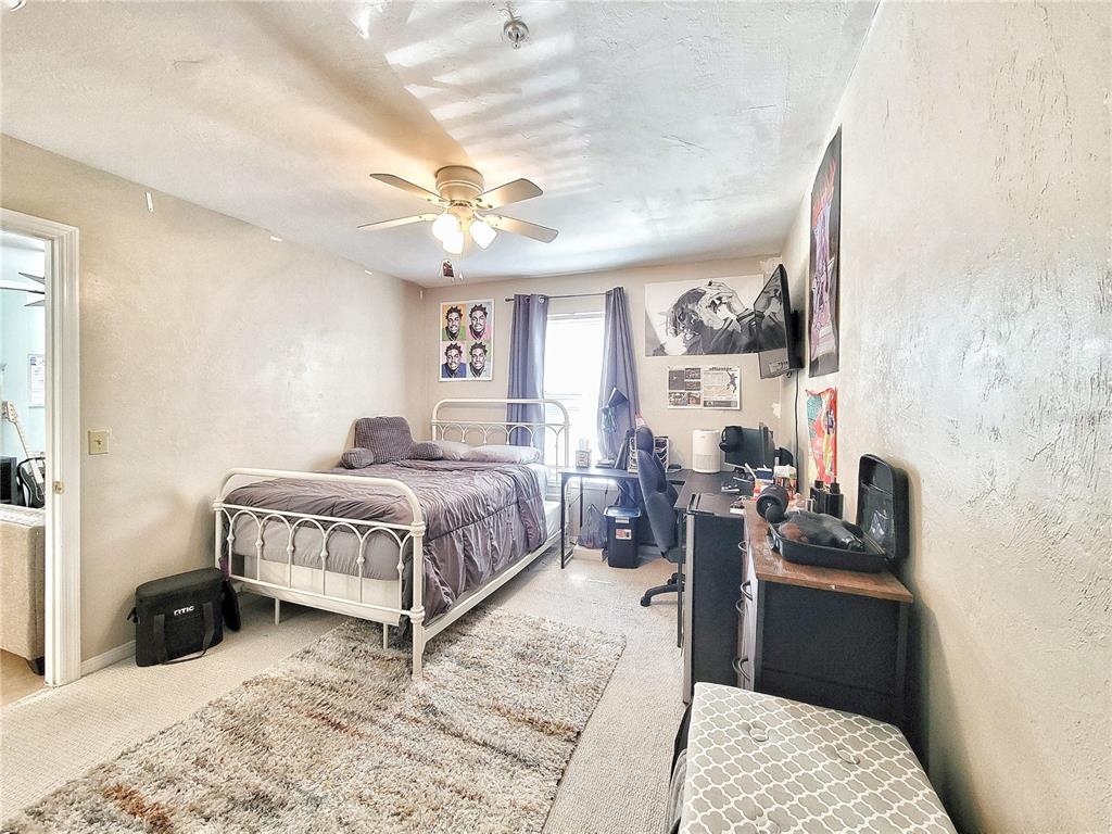 2360 Southwest Archer Road, Unit 801 Gainesville, FL 32608 - Photo 18 of 27 a bedroom with a bed couch and a window