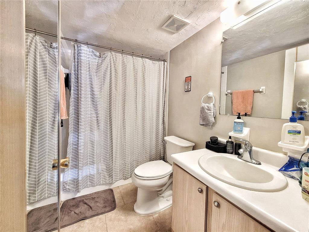 2360 Southwest Archer Road, Unit 801 Gainesville, FL 32608 - Photo 19 of 27 a bathroom with a sink toilet and shower