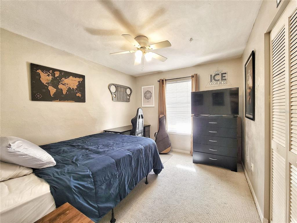 2360 Southwest Archer Road, Unit 801 Gainesville, FL 32608 - Photo 20 of 27 a bedroom with a bed and a chandelier