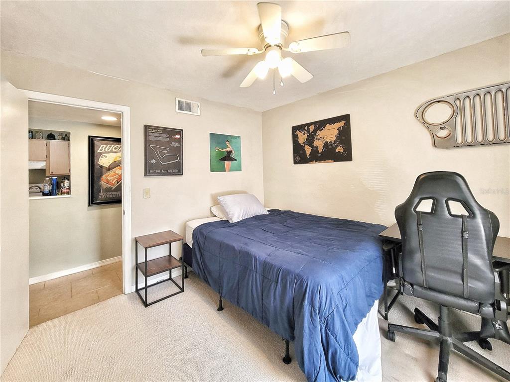 2360 Southwest Archer Road, Unit 801 Gainesville, FL 32608 - Photo 21 of 27 a bedroom with a bed and a table in it