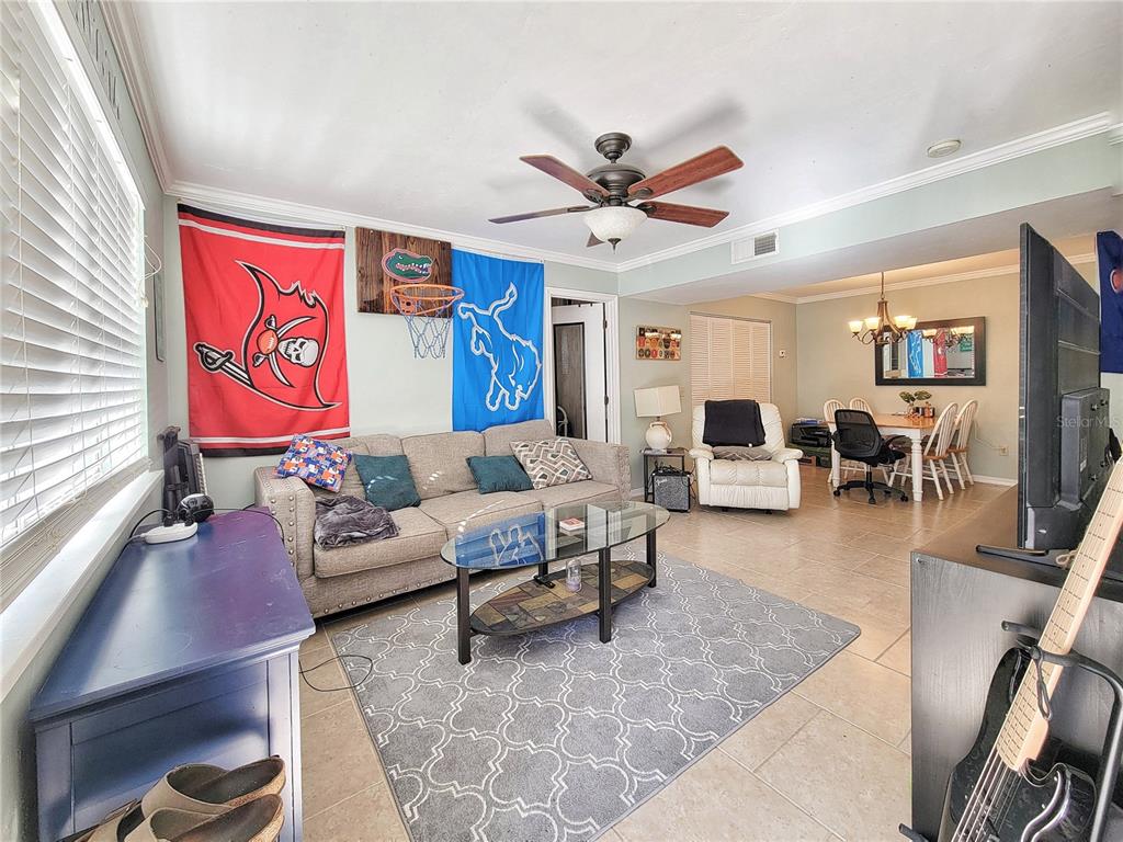 2360 Southwest Archer Road, Unit 801 Gainesville, FL 32608 - Photo 4 of 27 a living room with furniture and a large window