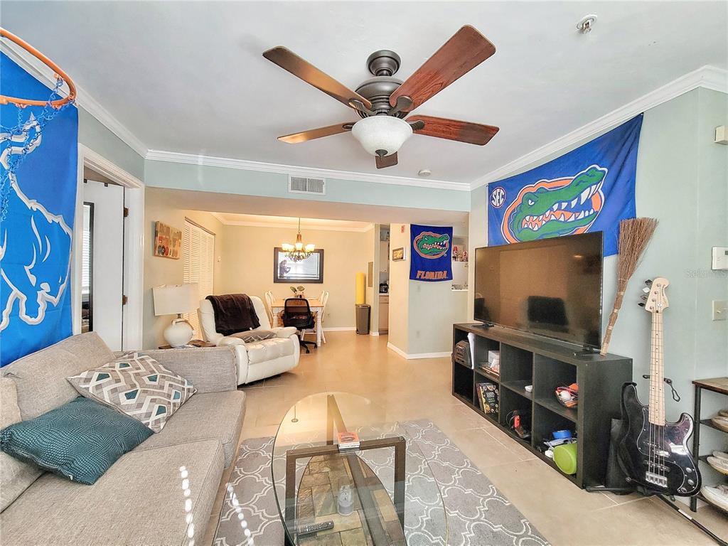 2360 Southwest Archer Road, Unit 801 Gainesville, FL 32608 - Photo 5 of 27 a living room with furniture and a flat screen tv