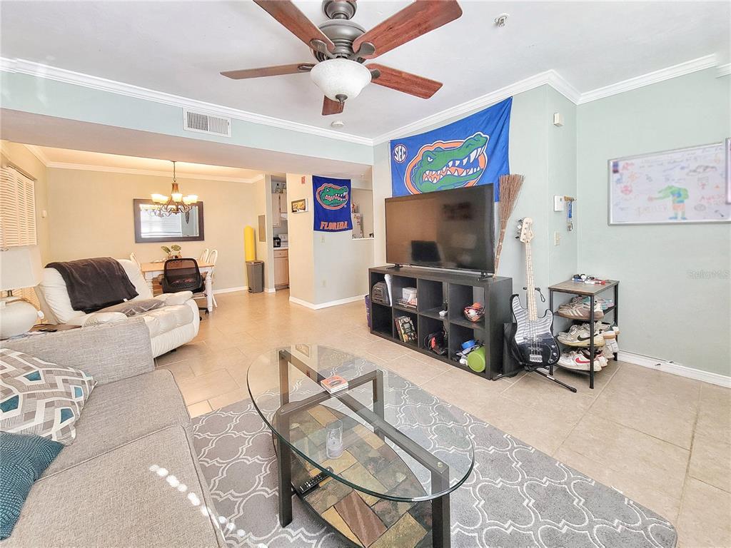 2360 Southwest Archer Road, Unit 801 Gainesville, FL 32608 - Photo 7 of 27 a living room with furniture and a flat screen tv