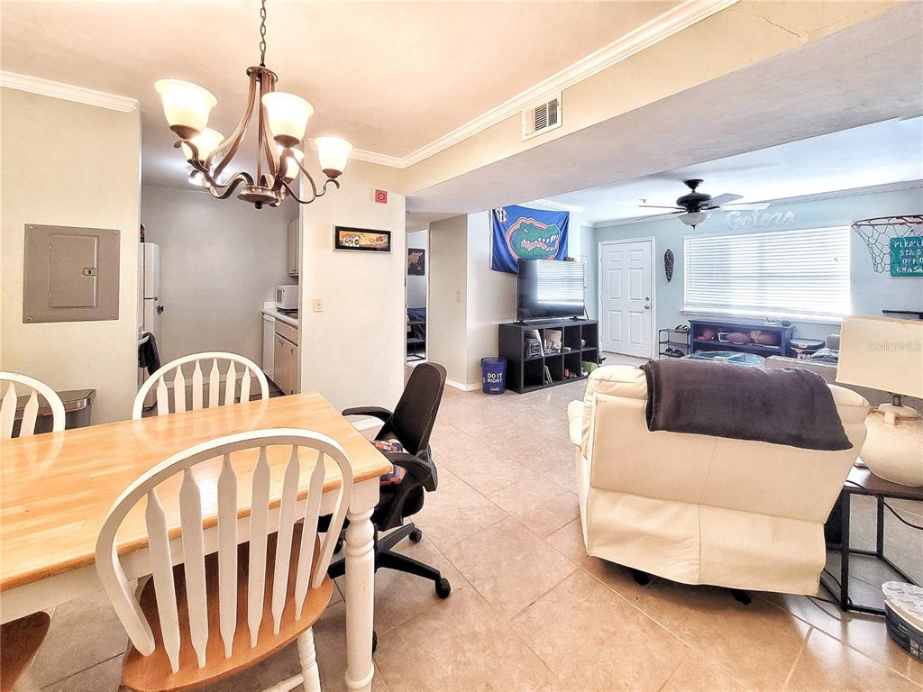 2360 Southwest Archer Road, Unit 801 Gainesville, FL 32608 - Photo 9 of 27 a living room with furniture a table and chairs