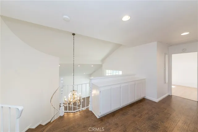 a view of a room with window and chandelier fan
