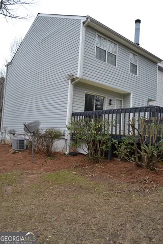 a view of a house with backyard and sitting area