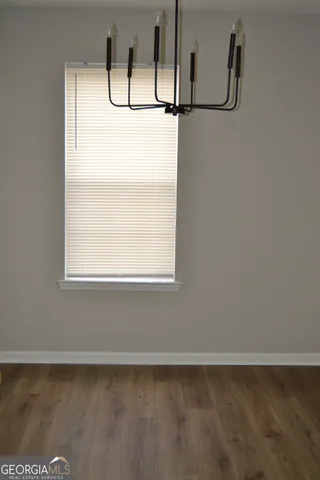 a view of a small space with wooden floor and windows