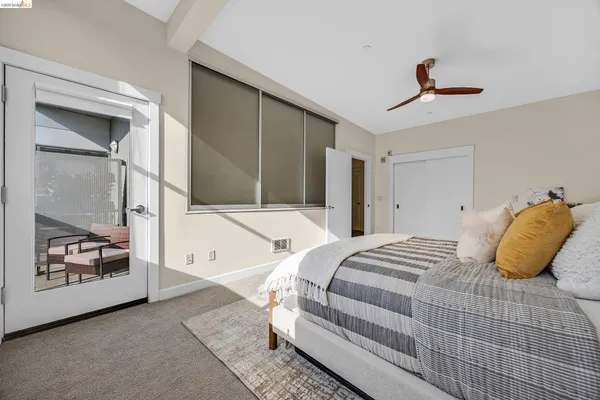 a bedroom with a bed and a painting on the wall