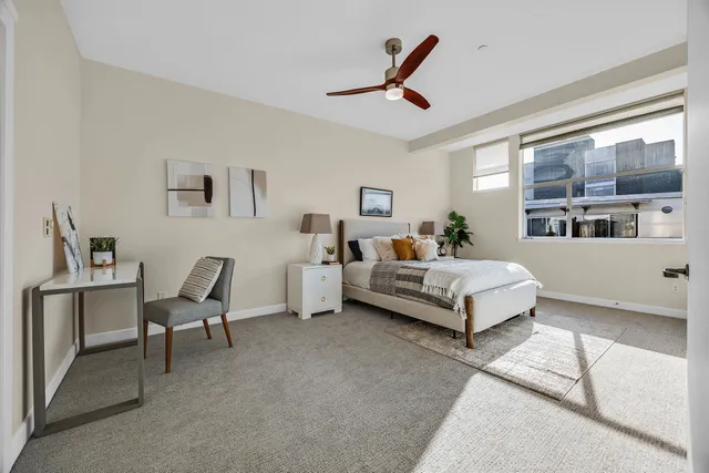 a bedroom with a bed couch and a window