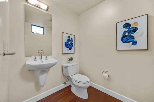 a bathroom with a toilet a sink and mirror
