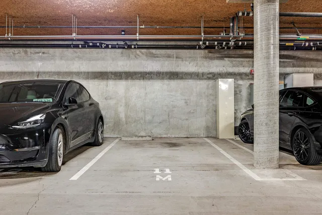 a view of parking garage with cars parked