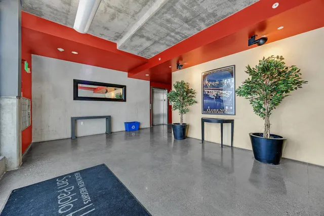 a lobby with furniture and potted plant