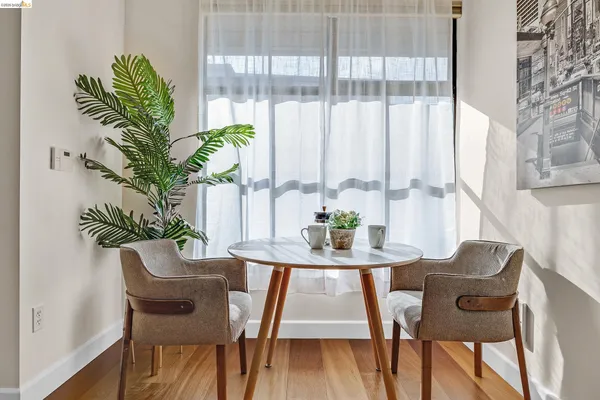 a view of a dining room with furniture window and wooden floor