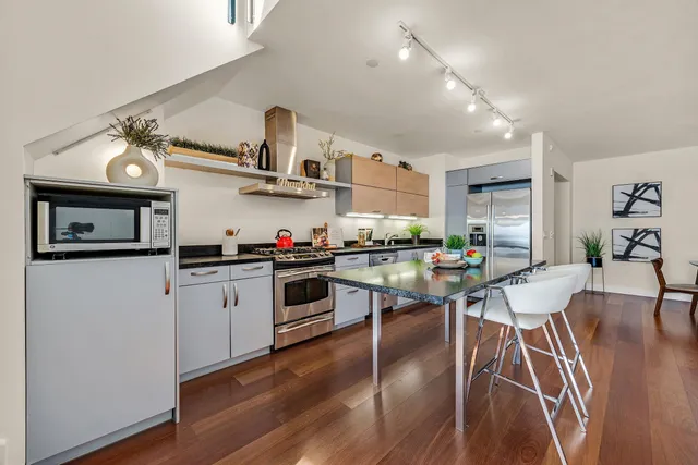 a kitchen with cabinets and wooden floor