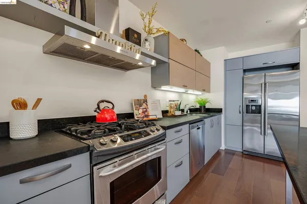 a kitchen with stainless steel appliances granite countertop a stove and a refrigerator