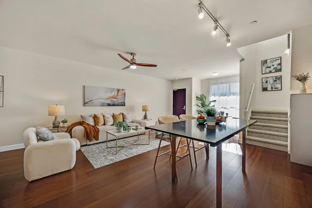 a living room with furniture and wooden floor