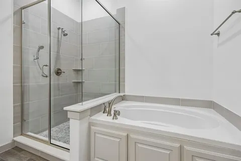 a bathroom with a tub and a shower