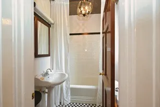 a spacious bathroom with a granite countertop sink mirror and a shower