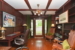 a living room with furniture a flat screen tv and large windows