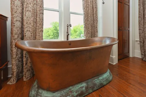 a view of a livingroom with furniture window and wooden floor