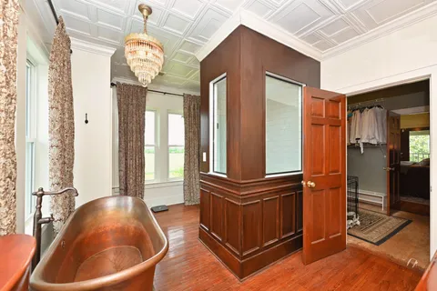 a living room with a fireplace and wooden floor