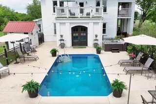 a view of swimming pool with sitting area and furniture