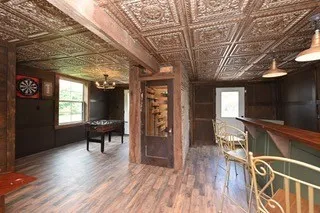 a dining room with furniture a chandelier and wooden floor