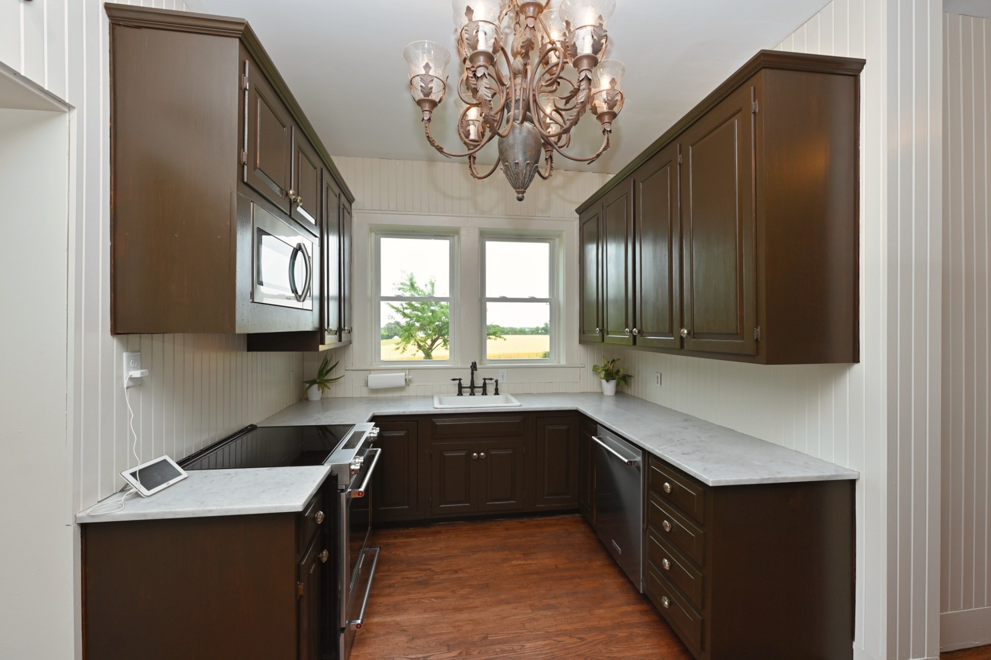 6538 Highway 431 Springfield, TN 37172 - Photo 60 of 63 a kitchen with a sink dishwasher a stove and a refrigerator with wooden floor