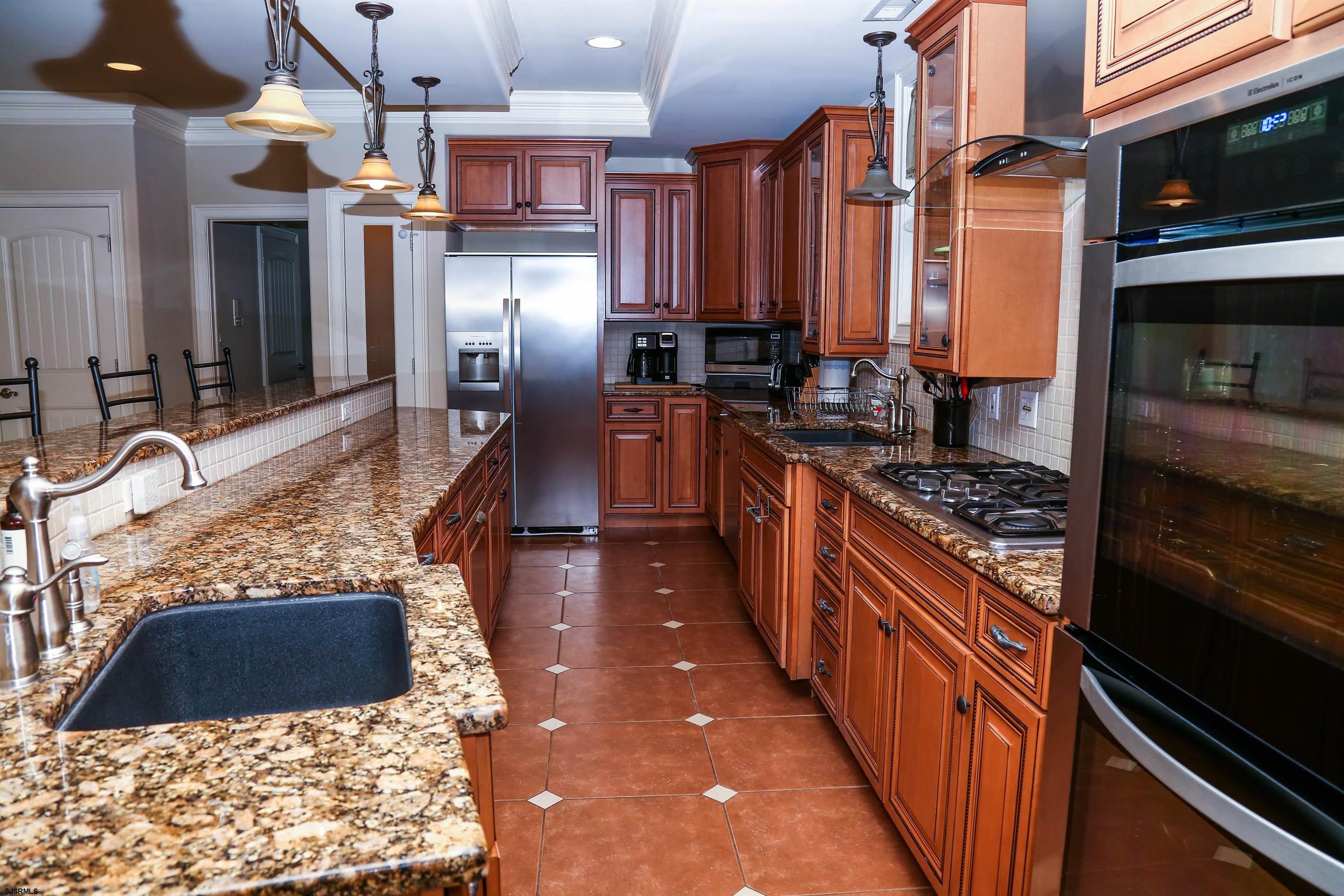339 South 13th Street Brigantine, NJ 08203 - Photo 22 of 57 a kitchen with stainless steel appliances granite countertop a stove a sink and a refrigerator
