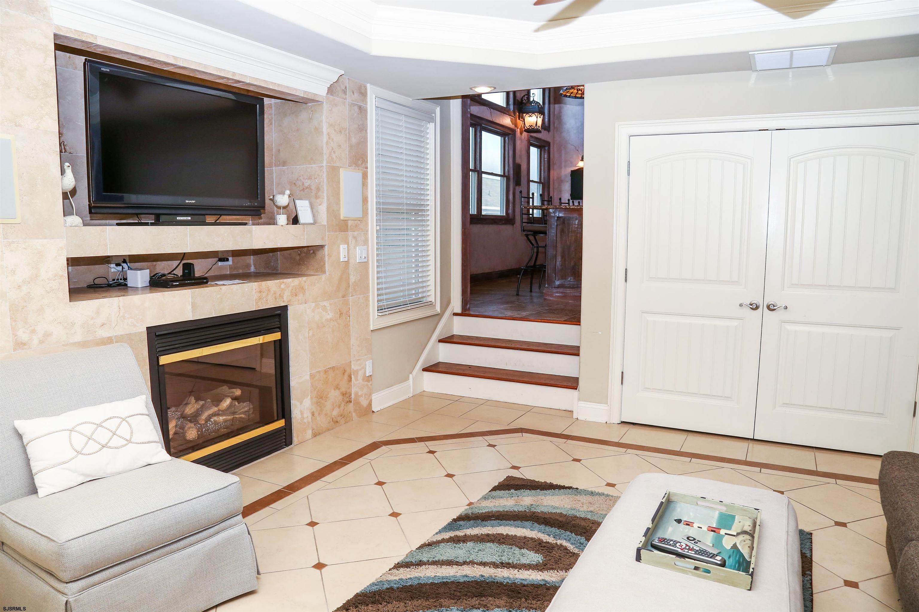 339 South 13th Street Brigantine, NJ 08203 - Photo 27 of 57 a living room with a flat screen tv and a fireplace