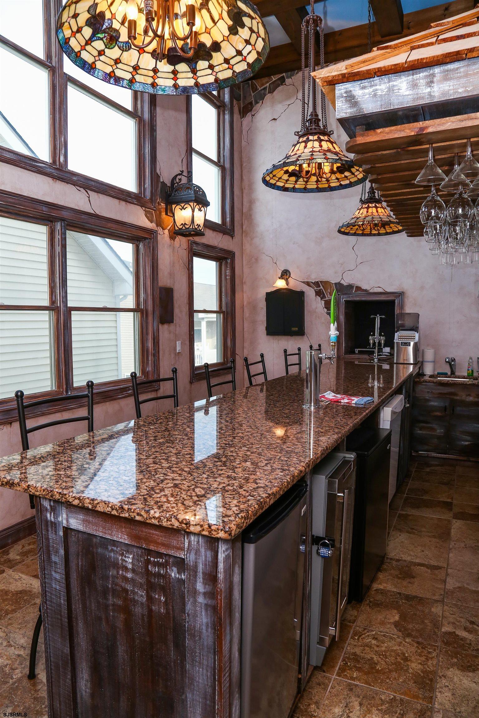 339 South 13th Street Brigantine, NJ 08203 - Photo 30 of 57 a kitchen with stainless steel appliances granite countertop a sink a stove and a wooden cabinets