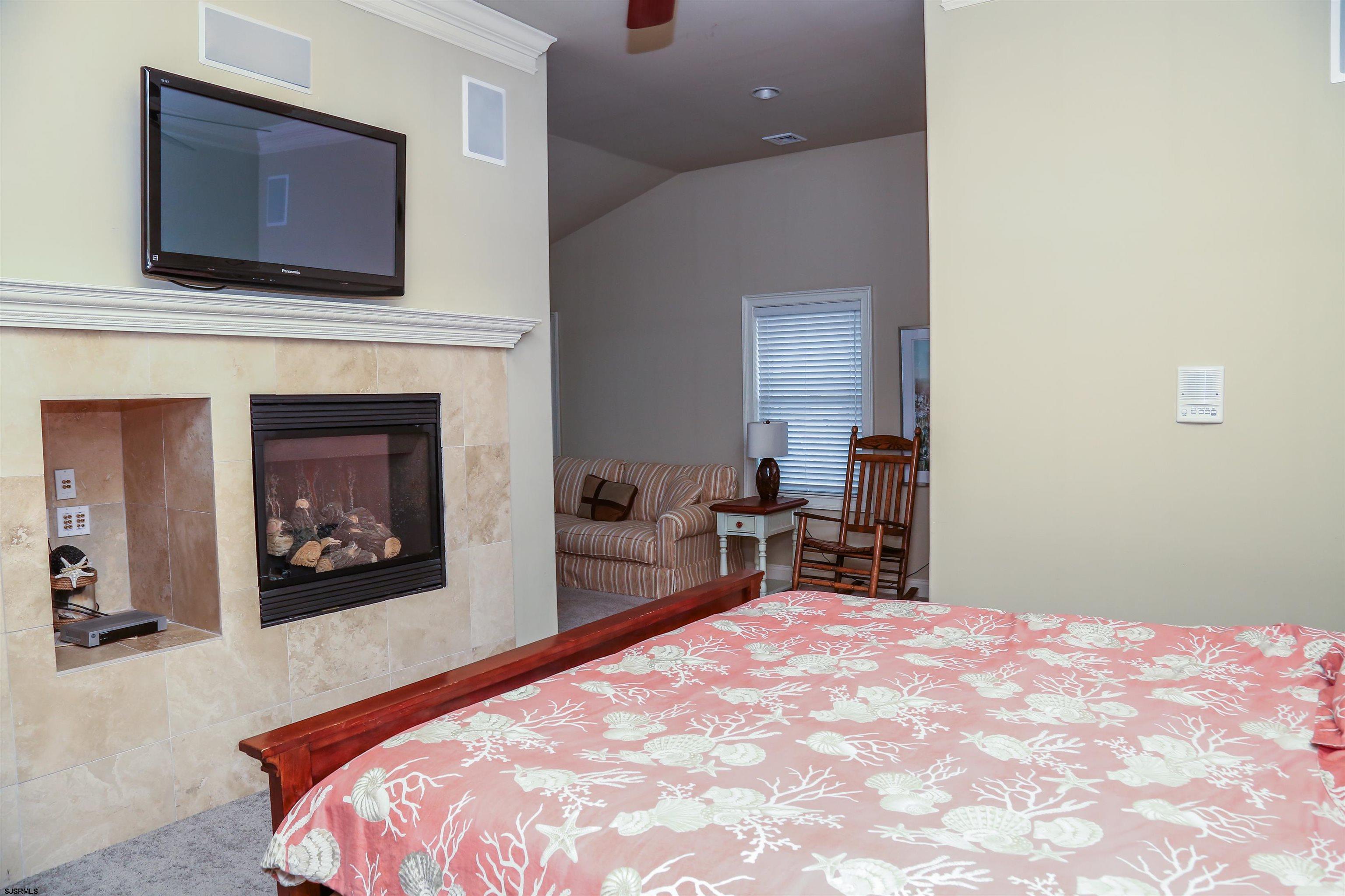 339 South 13th Street Brigantine, NJ 08203 - Photo 37 of 57 a bedroom with a bed and a fireplace