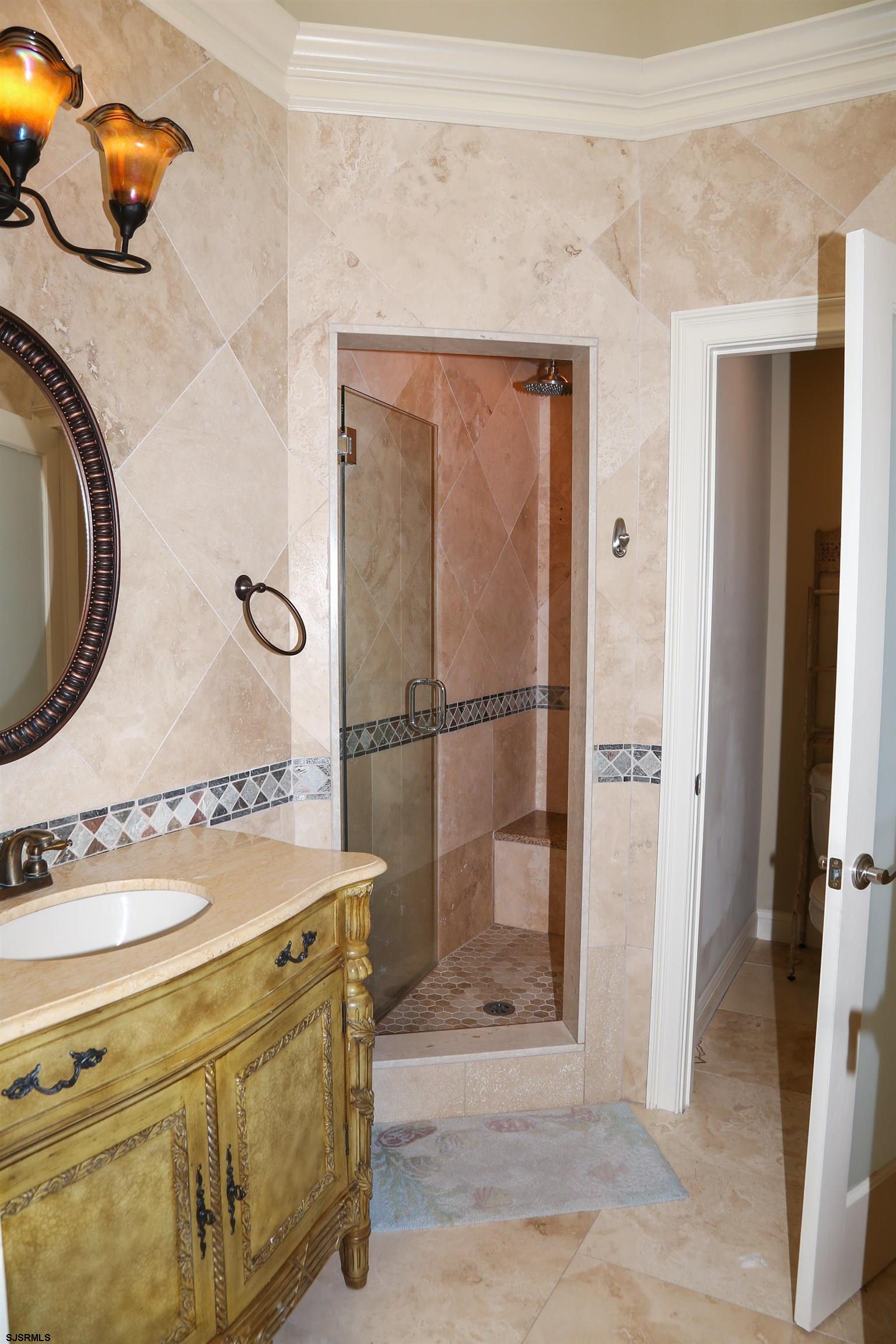 339 South 13th Street Brigantine, NJ 08203 - Photo 41 of 57 a bathroom with a sink and a mirror